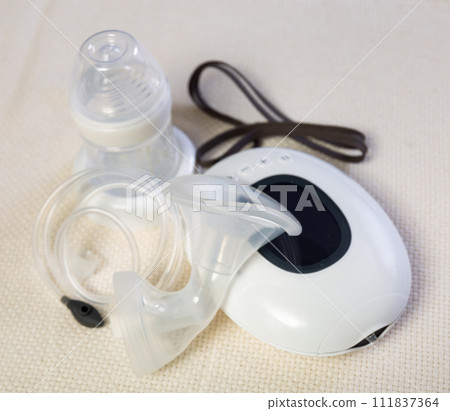 Isolated electric portable breast pump with blank bottle and replaceable nipple for feeding newborn Isolated electric portable breast pump with blank bottle and replaceable nipple for feeding newborn 111837364