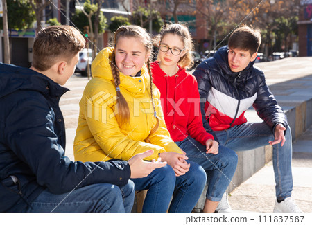Teenagers gathering outdoors Teenagers gathering outdoors 111837587