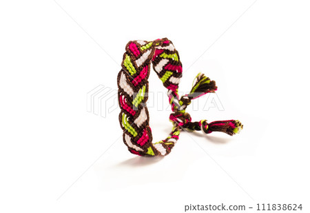 Multicolored woven DIY friendship bracelets handmade of embroidery bright thread with knots isolated on white background Multicolored woven DIY friendship bracelets handmade of embroidery bright thread with knots isolated on white background 111838624