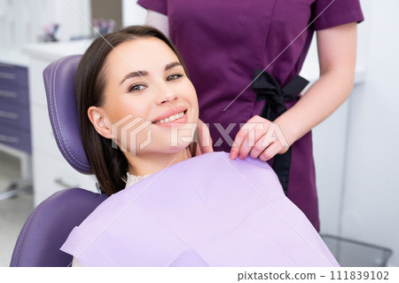 Portrait of young woman before checking up teeth at dentist office. Portrait of young woman before checking up teeth at dentist office. 111839102