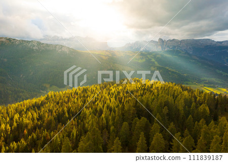 The Sun Shines Through the Clouds Over the Seceda Mountains. The Sun Shines Through the Clouds Over the Seceda Mountains. 111839187