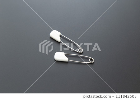 Safety pin black background Safety pin black background 111842503
