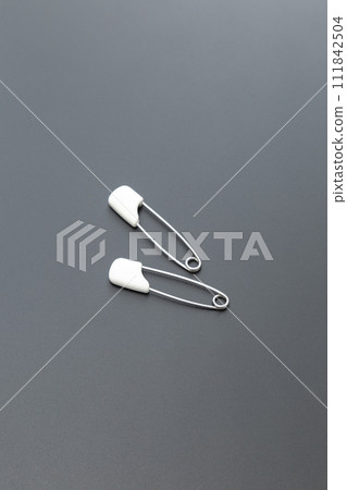 Safety pin black background Safety pin black background 111842504