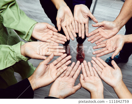 Diverse Hands Circle Symbolizing Team Inclusivity and Cooperation; Unity with Interlocked Hands Diverse Hands Circle Symbolizing Team Inclusivity and Cooperation; Unity with Interlocked Hands 111842759