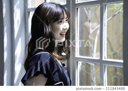 A woman relaxing by the window 111843480