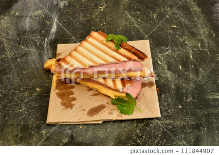 Sandwiches with cheese and sausage on the table. 111844907