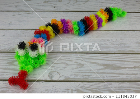 Toy snake made of multi colored burdocks Toy snake made of multi colored burdocks 111845037