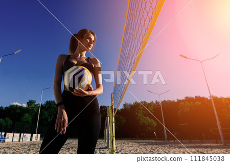 A female beach volleyball athlete with ball on the volleyball court 111845038