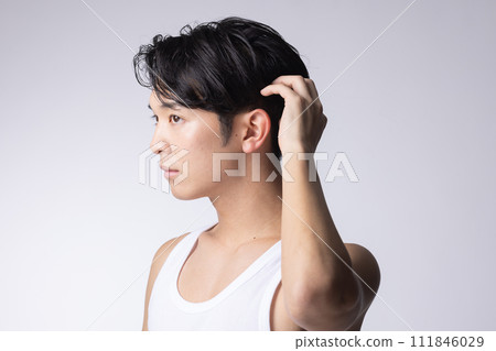 Portrait of a man who cares about his hairstyle on a white background Portrait of a man who cares about his hairstyle on a white background 111846029