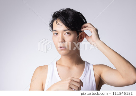 Portrait of a man who cares about his hairstyle on a white background 111846181