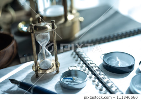 Conceptual image photo with compass and hourglass Conceptual image photo with compass and hourglass 111846660