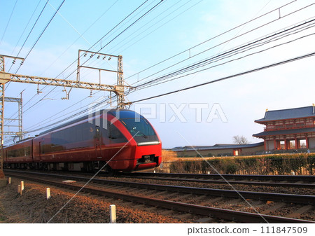 The Kintetsu Limited Express Hitotori runs past the Suzakumon Gate inside the World Heritage Site Nara Heijo Palace Ruins The Kintetsu Limited Express Hitotori runs past the Suzakumon Gate inside the World Heritage Site Nara Heijo Palace Ruins 111847509