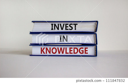 Time to invest in knowledge. Books with text 'invest in knowledge' on beautiful white background. Business and invest in knowledge concept. Copy space. 111847832