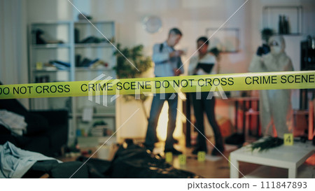 Do not cross the crime scene tape that secures the perimeter; detectives are conducting the investigation 111847893