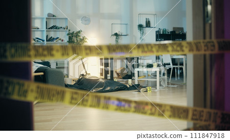 A dead body is lying in a bag in the trashed apartment, secured by police crime scene tape 111847918