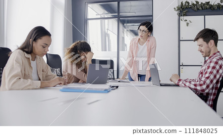 Angry female boss criticizing employees during business meeting, management Angry female boss criticizing employees during business meeting, management 111848025