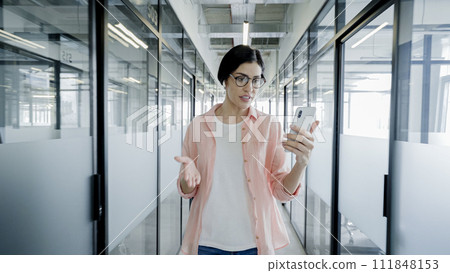 Female employee talking to business partner online, using smartphone application 111848153