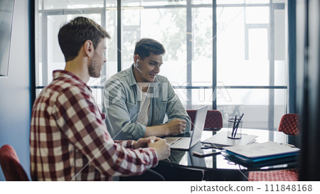Startup owners watching presentation online, discussing business plan in office, brainstorm 111848168
