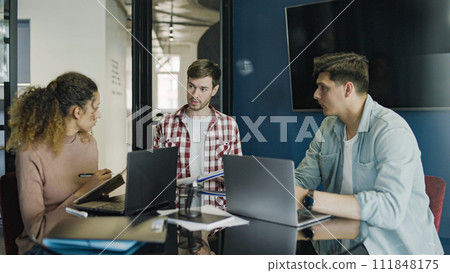 Team of business people developing plan of startup, communication in office Team of business people developing plan of startup, communication in office 111848175