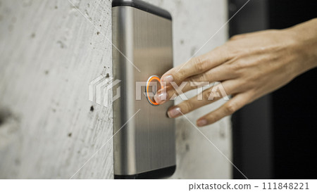 Female hand pressing elevator button, woman in office building, destination 111848221
