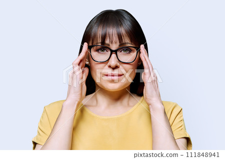 Headshot portrait of serious mature woman on white background 111848941