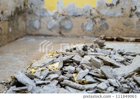 A room under renovation with debris of broken walls and plaster on the floor. A room under renovation with debris of broken walls and plaster on the floor. 111849063