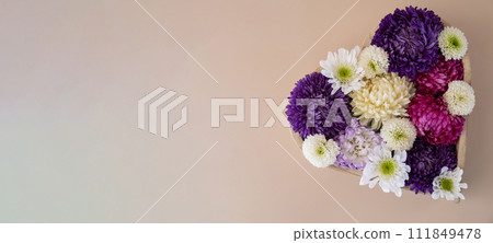 Colorful mixed flowers in shape of heart on beige background. Concept of love and valentines day, weeding, anniversary. Postcard greeting card template. Flat lay minimalistic Colorful mixed flowers in shape of heart on beige background. Concept of love and valentines day, weeding, anniversary. Postcard greeting card template. Flat lay minimalistic 111849478
