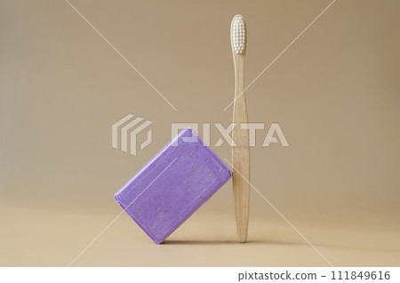 Bamboo toothbrush and Lavender soap on beige background with copy space for your text. Advertisement template mock up. Skincare homemade natural cosmetic concept. Organic dry lavender flower 111849616