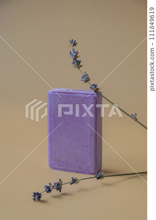 Handcrafted purple lavender soap with lavender flowers. Natural hydrating moisturiser softness cosmetic. Organic calming beauty skincare product. Herbal self care wellness alternative soap Handcrafted purple lavender soap with lavender flowers. Natural hydrating moisturiser softness cosmetic. Organic calming beauty skincare product. Herbal self care wellness alternative soap 111849619