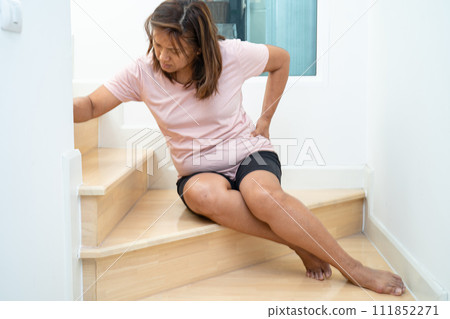 Asian lady fall down the stairs and pain at hip and waist because slippery surfaces. Asian lady fall down the stairs and pain at hip and waist because slippery surfaces. 111852271