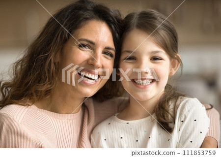 Positive mom and happy tween kid girl looking at camera 111853759