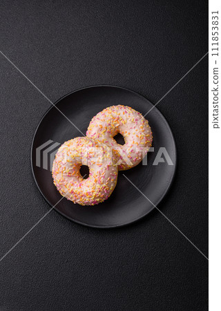 Delicious sweet bright donuts with cream on a plain background 111853831