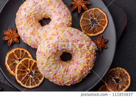 Delicious sweet bright donuts with cream on a plain background 111853837
