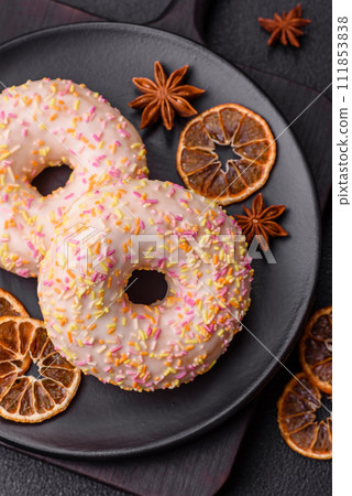 Delicious sweet bright donuts with cream on a plain background 111853838