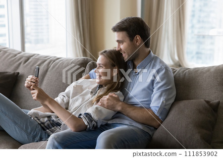 Young couple spend free time using modern smartphone 111853902