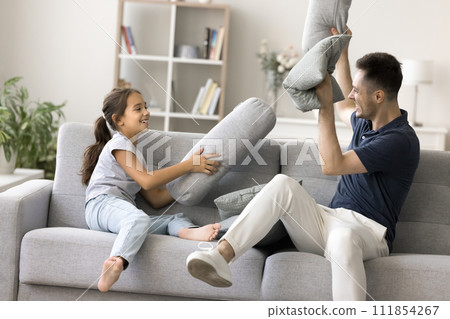 Happy excited young father and energetic kid girl having fun Happy excited young father and energetic kid girl having fun 111854267