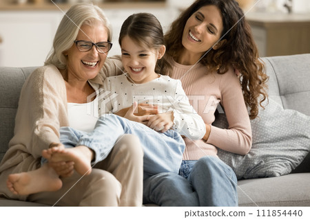 Happy joyful grandma and mom playing with cheerful kid 111854440