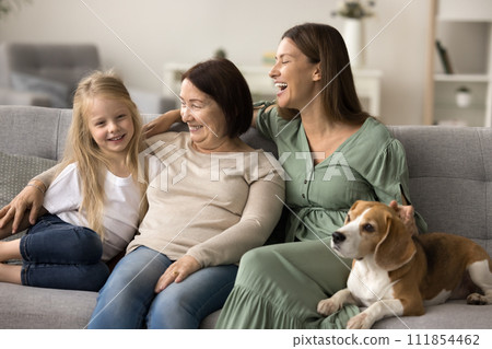 Cheerful mom with adorable dog, grandma and girl enjoying meeting Cheerful mom with adorable dog, grandma and girl enjoying meeting 111854462