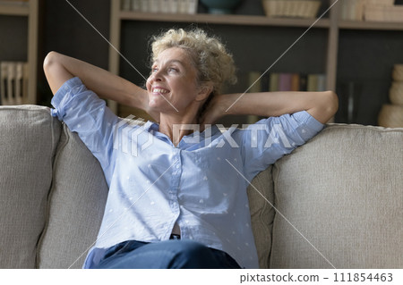 Happy mature female spending carefree leisure indoors Happy mature female spending carefree leisure indoors 111854463