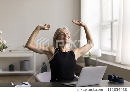 Woman relax on comfy chair after end of working day Woman relax on comfy chair after end of working day 111854488