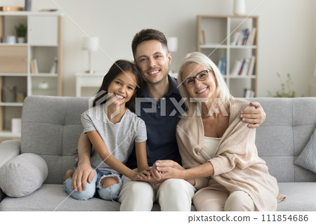Pretty cute preteen girl kid, dad and grandma sitting together 111854686
