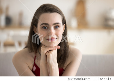 Head shot portrait of cute young woman staring at camera 111854813