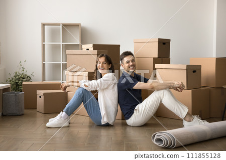 Happy couple beginning living together in new flat Happy couple beginning living together in new flat 111855128