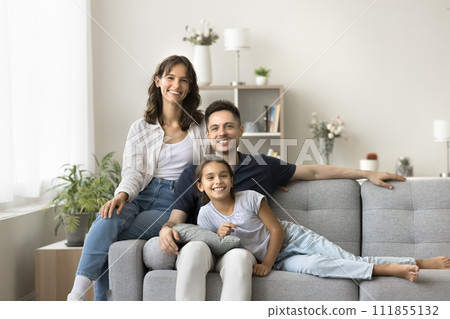 Cheerful young parents and cute tween girl kid relaxing together 111855132