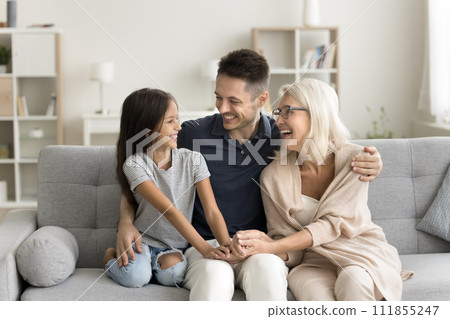 Cheerful kid girl and young dad visiting happy grandmother Cheerful kid girl and young dad visiting happy grandmother 111855247