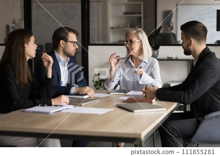 Older mature business team manager woman motivating employees for teamwork 111855281
