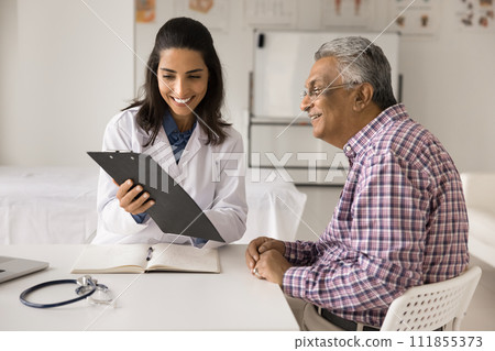 Cheerful doctor woman showing medical report to elderly patient man Cheerful doctor woman showing medical report to elderly patient man 111855373