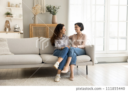Loving mother enjoy pleasant conversation with grown up daughter 111855440