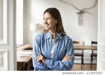 Happy dreamy successful beautiful entrepreneur woman posing in office apartment 111855567