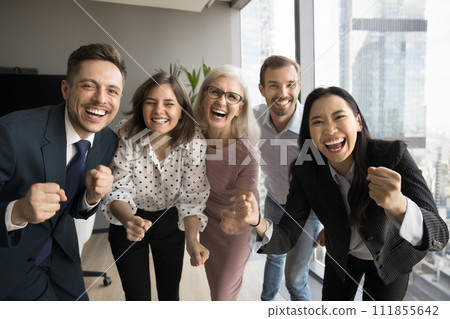 Team of colleagues and older leader woman screaming for joy Team of colleagues and older leader woman screaming for joy 111855642